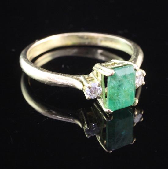 An 18ct gold and three stone emerald and diamond ring, size P.